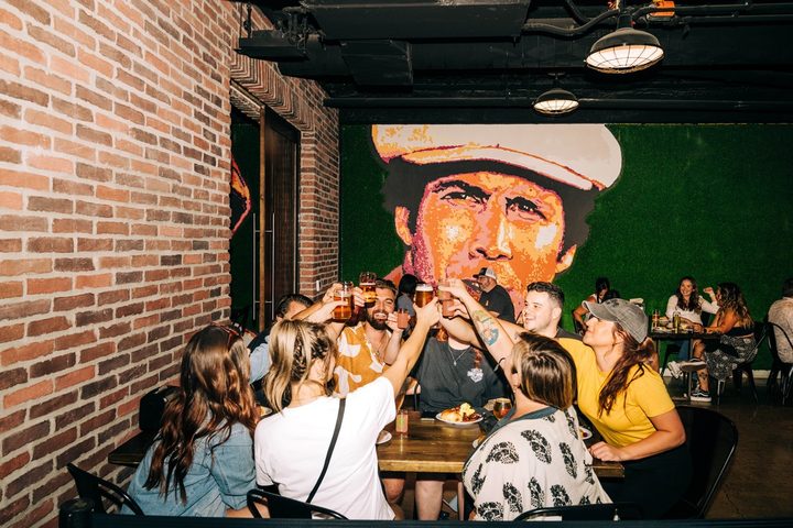 Guests toasting at a Tipsy Putt event
