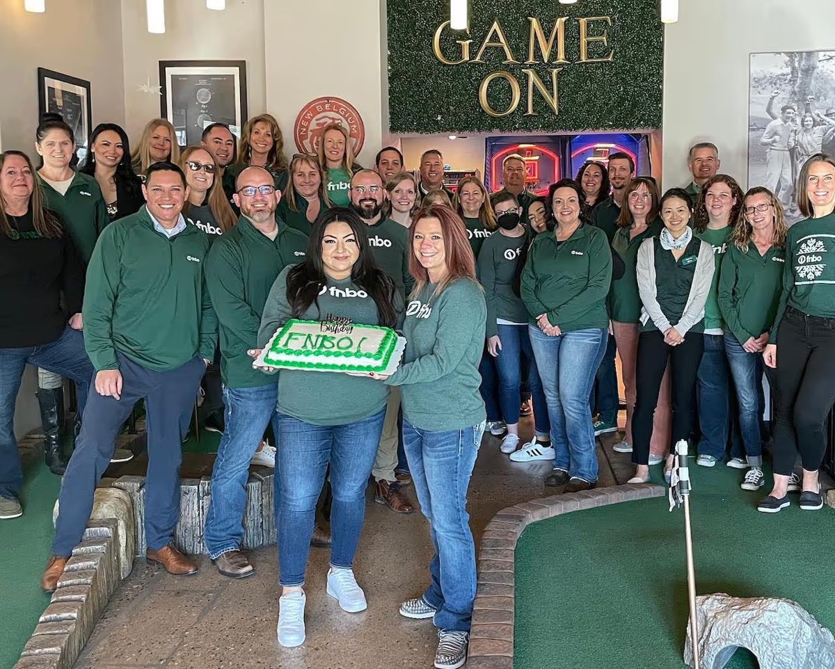 A company team celebrating an event at Old Town Putt
