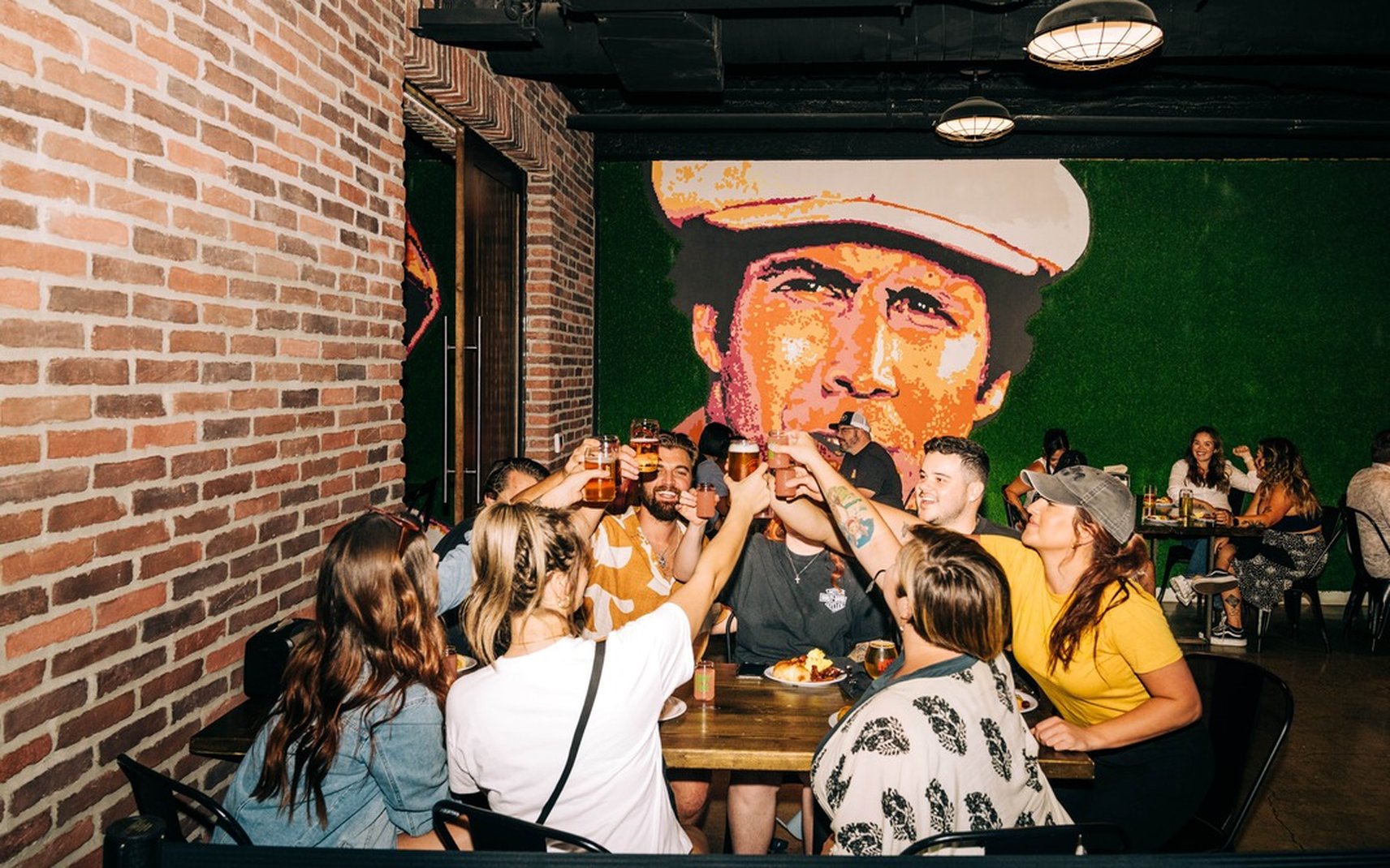 A group raising glasses for a toast at Tipsy Putt