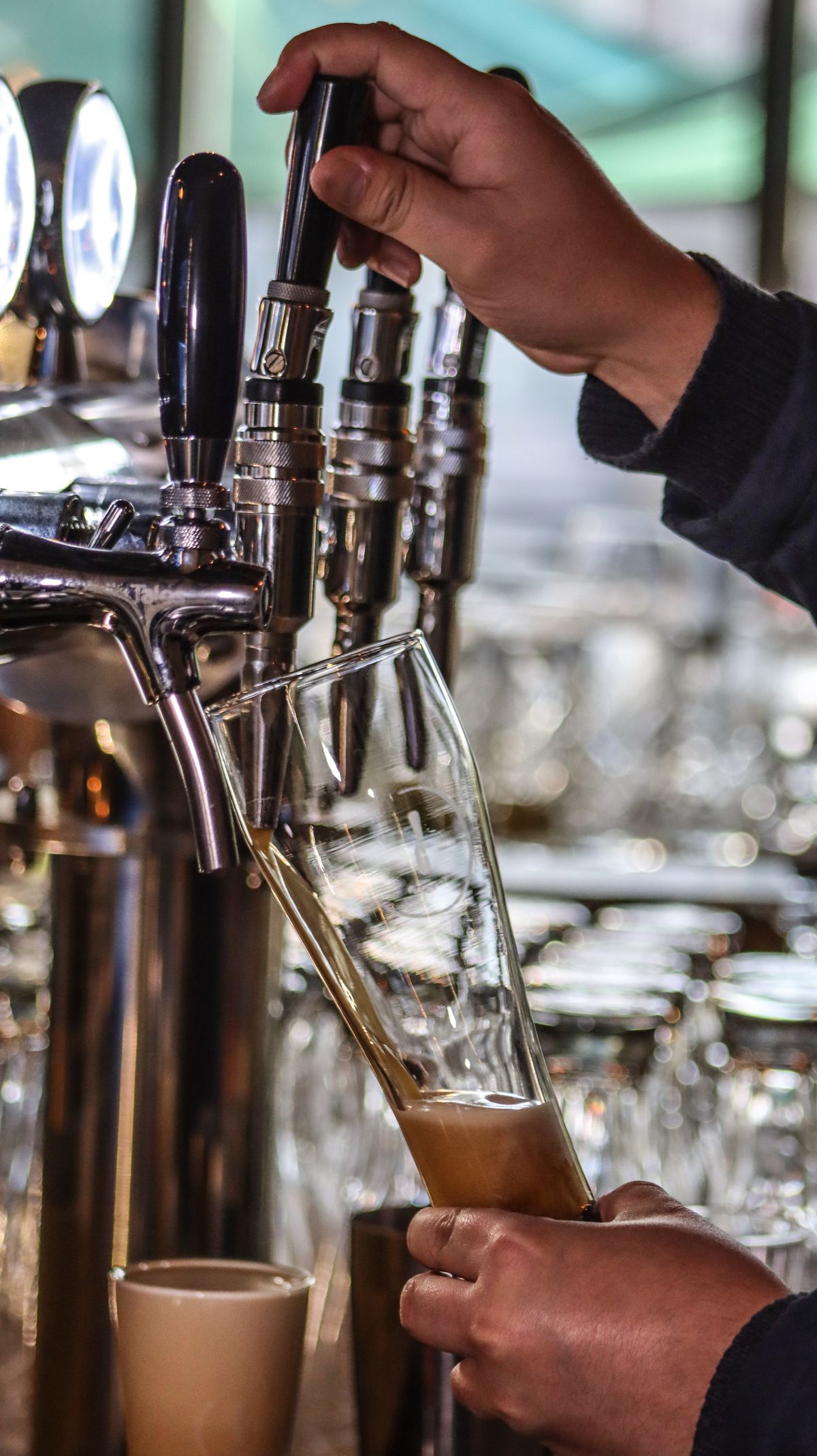Bartender pouring a fresh beer from the tap